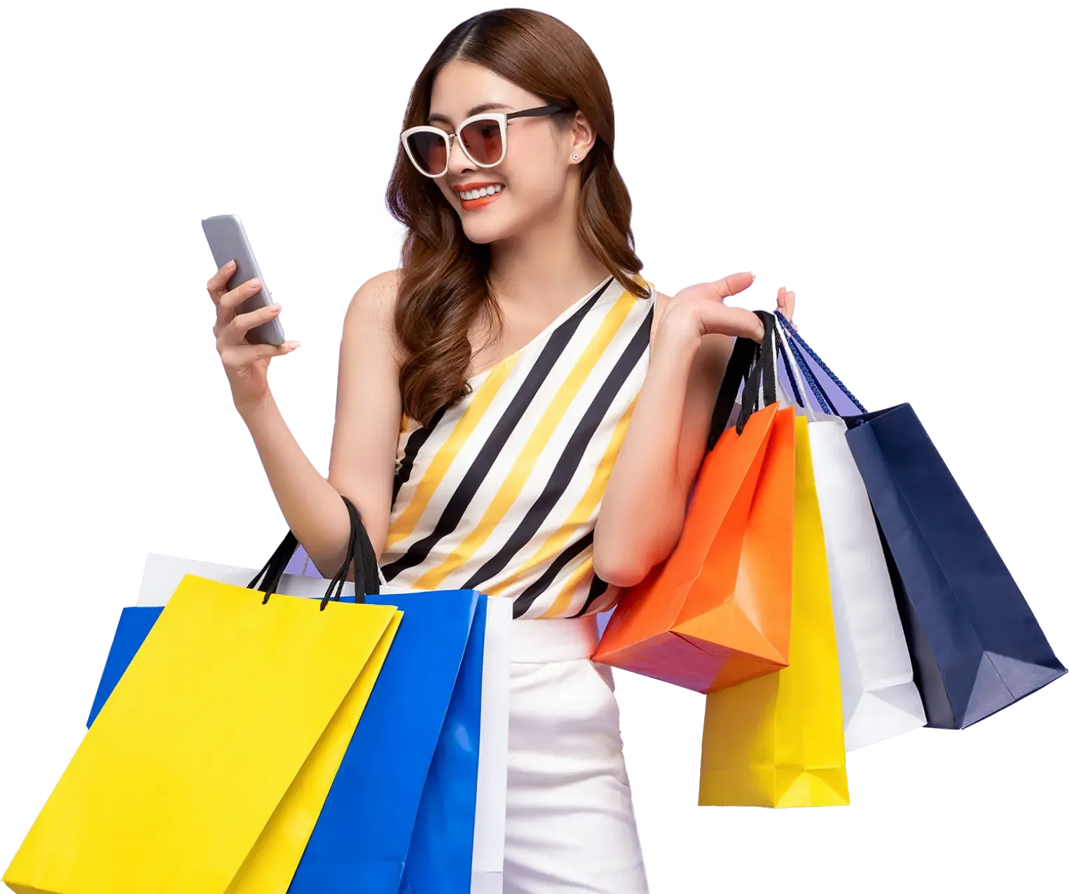 Happy woman holding multiple colorful shopping bags and using a smartphone