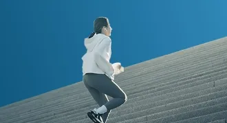 Person running up stairs, symbolizing Trinergy’s performance-focused approach