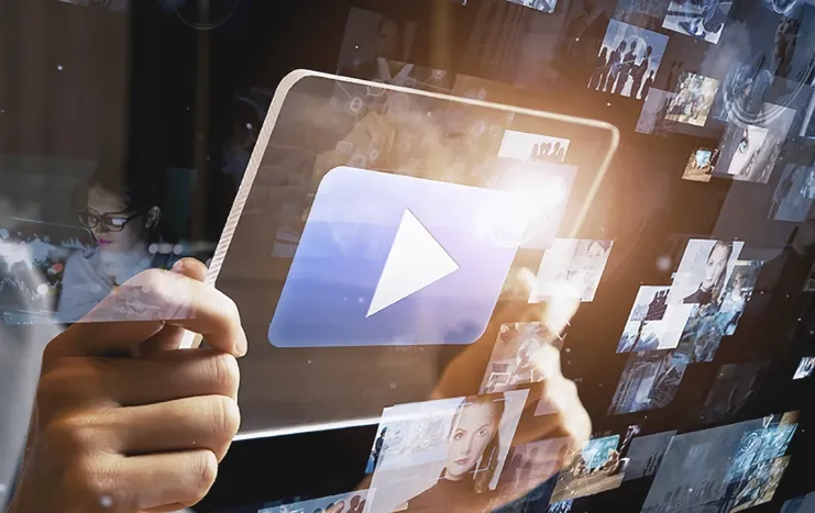 Person holding a digital tablet with a streaming play button, surrounded by video thumbnails