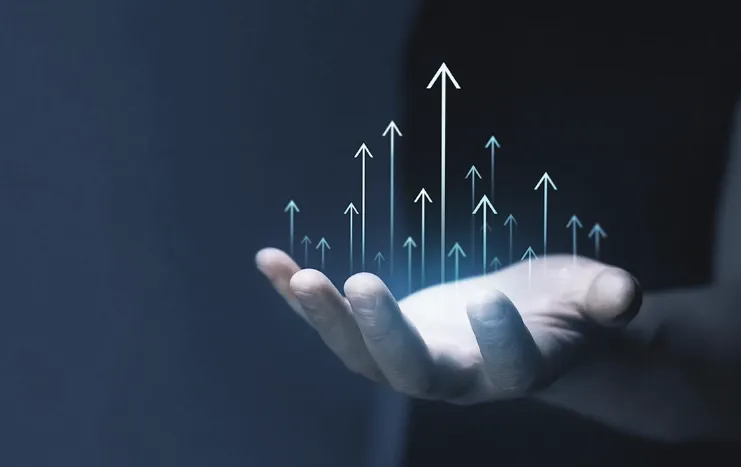 A hand holding upward-pointing digital arrows