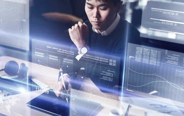 Professional analyzing data on a digital screen with graphs and metrics