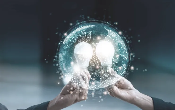 Two glowing light bulbs held within a digital globe