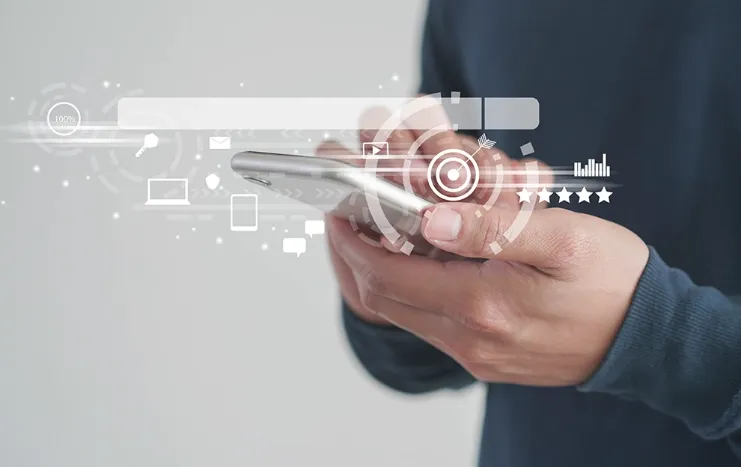 Person using a smartphone with digital analytics graphics