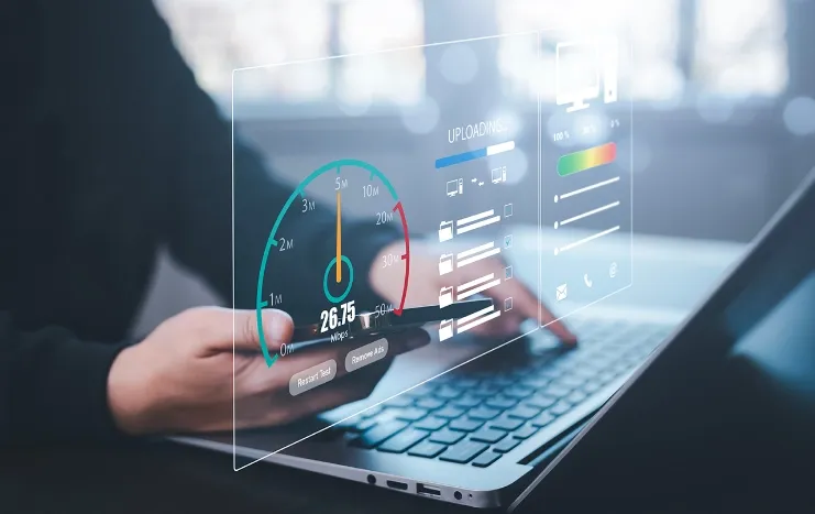 Close-up of a user analyzing performance metrics on a laptop and smartphone