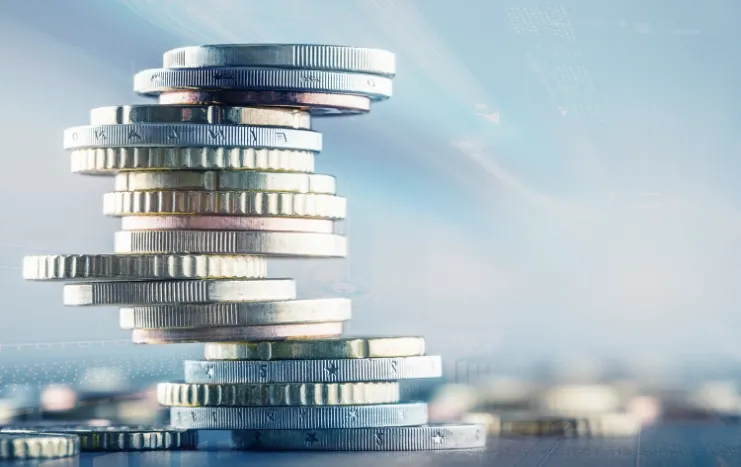 A stack of shining coins representing Trinergy's innovative solutions in financial technology