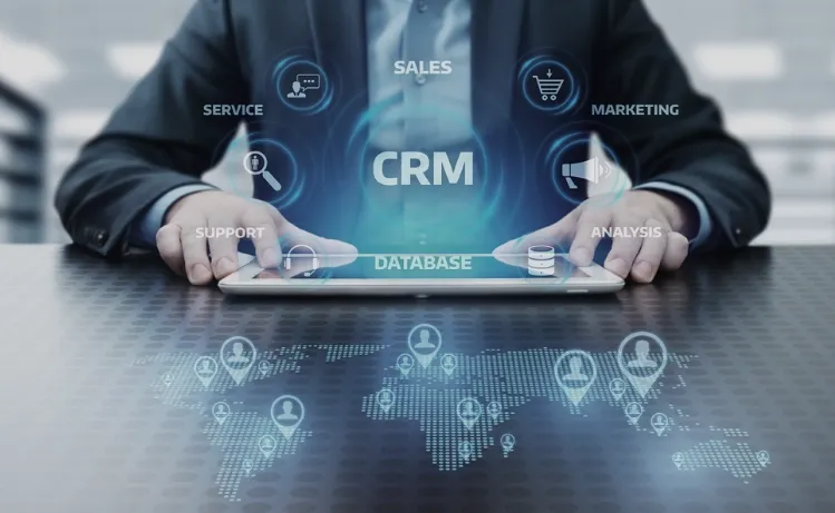 A person using a tablet displaying CRM software