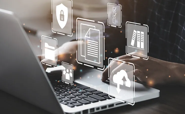 A person working on a laptop with floating digital icons representing data security, cloud storage