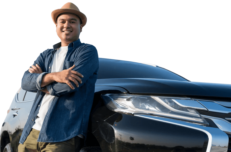 Smiling man confidently leaning on a black car