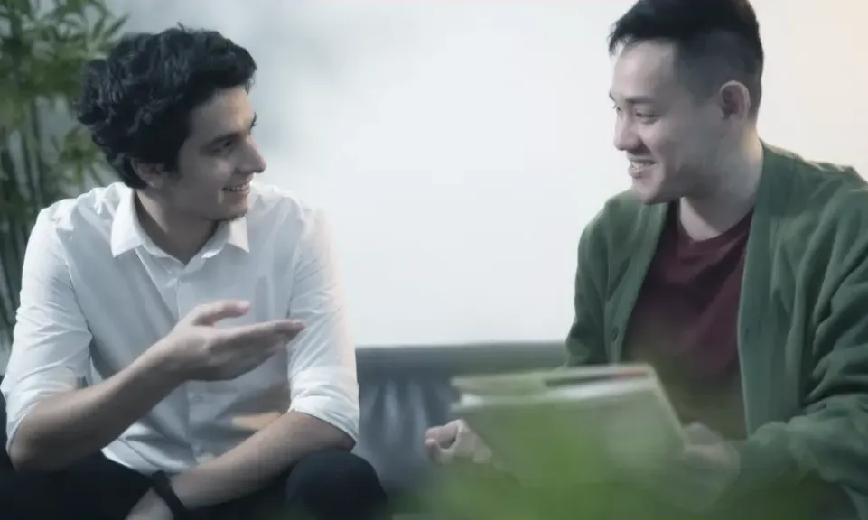 Two Trinergy colleagues in conversation at the office