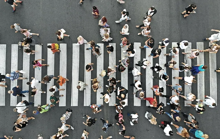 Trinergy crowd analytics concept showing people crossing a busy crosswalk, illustrating urban movement and data insights for smart city solutions.