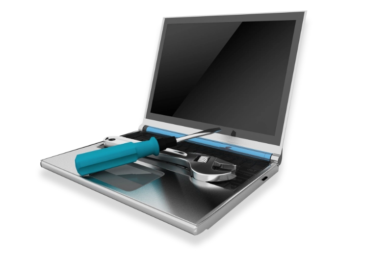 A laptop with a screwdriver and wrench on the keyboard