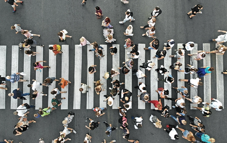 Trinergy crowd analytics concept showing people crossing a busy crosswalk, illustrating urban movement and data insights for smart city solutions.
